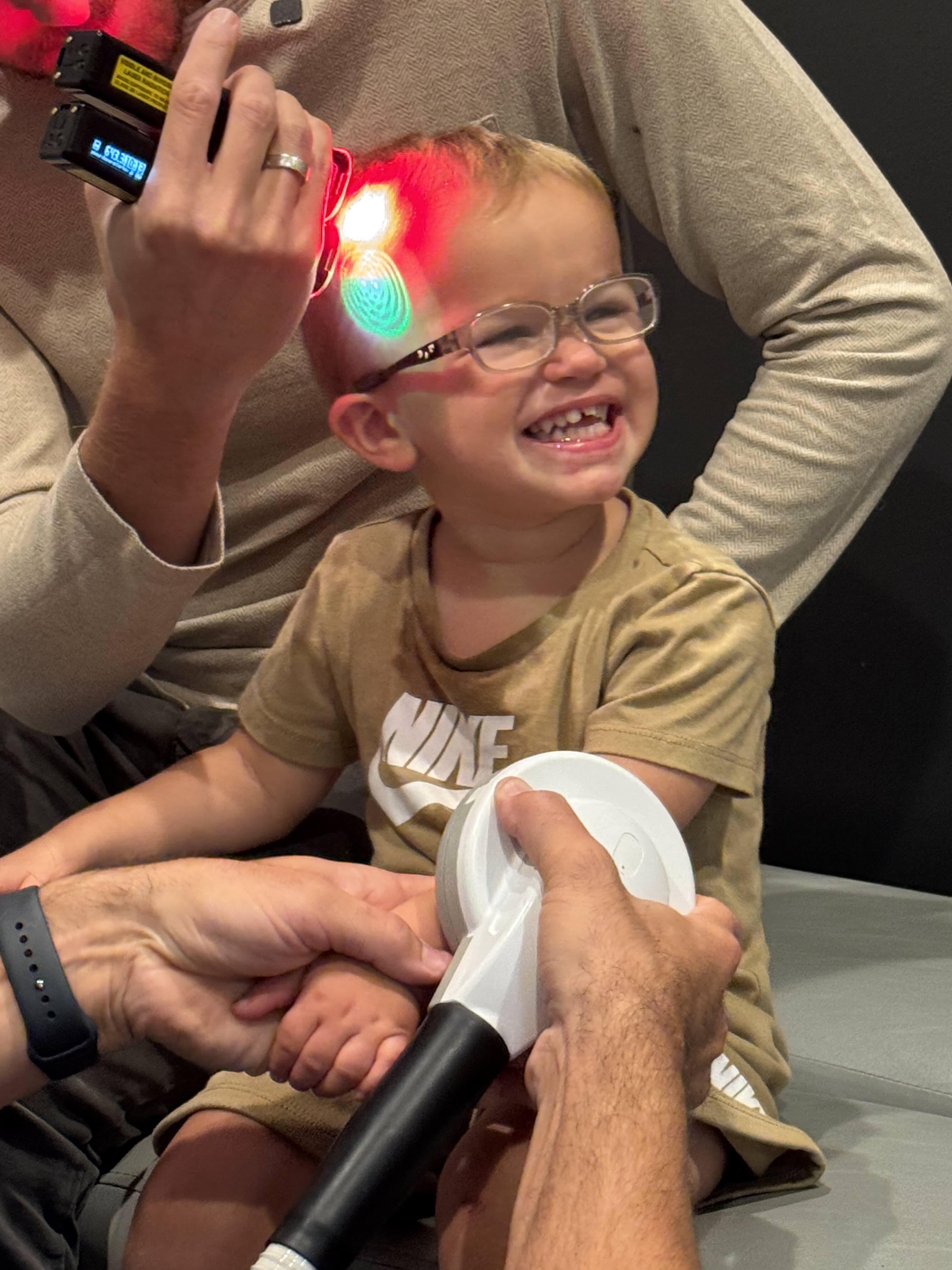 Happy child receiving laser therapy